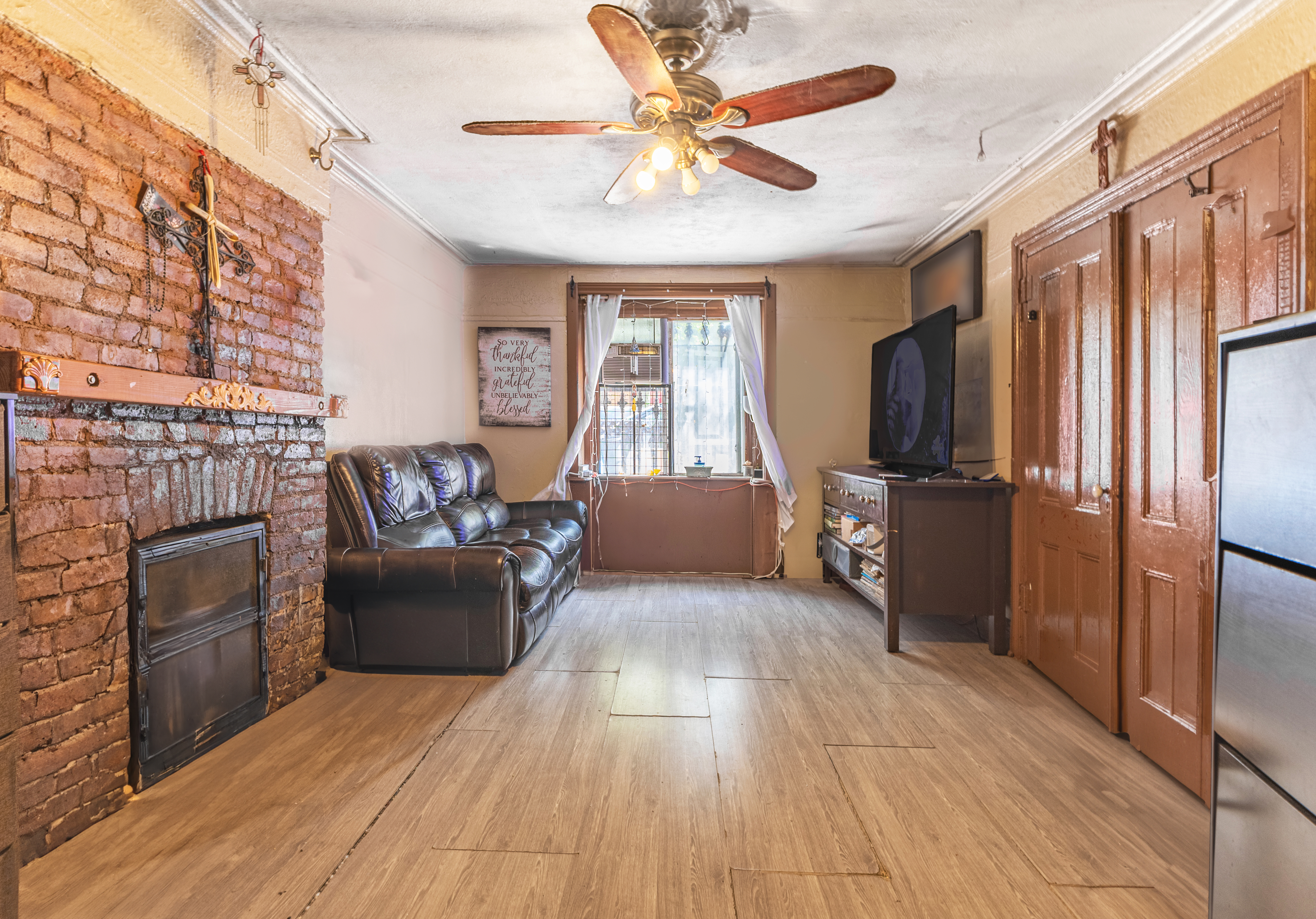 799 Willoughby Avenue Brooklyn, NY 11206 - Photo 3 of 12 a living room with furniture and a fireplace