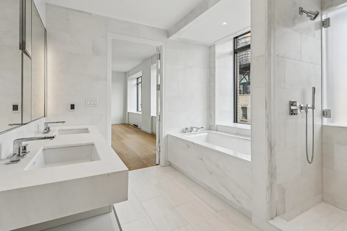 269 West 87th Street, Unit 14A Manhattan, NY 10024 - Photo 8 of 23 a bathroom with a tub sink and mirror
