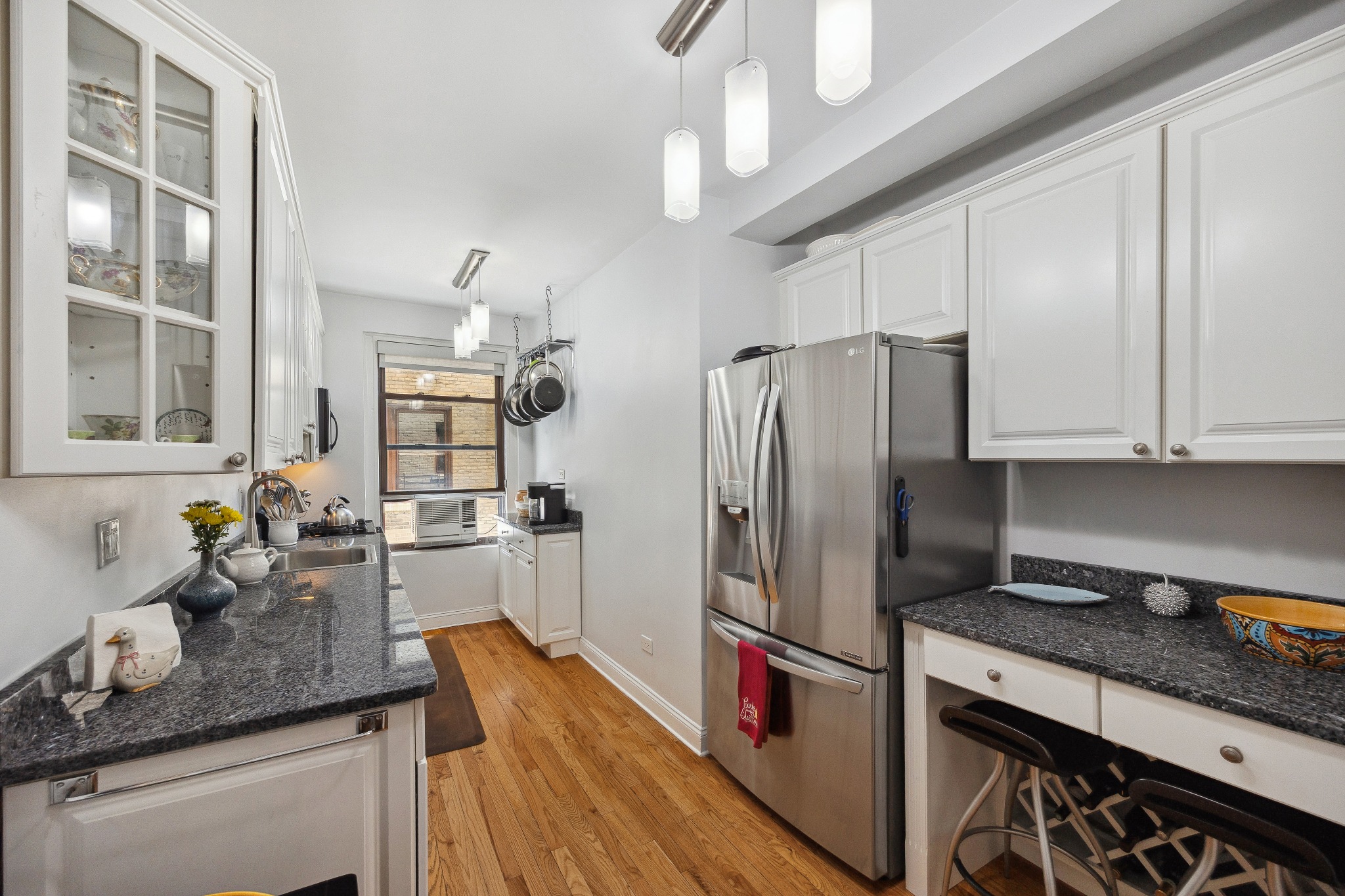 40 West 77th Street, Unit 8C Manhattan, NY 10024 - Photo 9 of 21 a kitchen with stainless steel appliances granite countertop a refrigerator and a sink