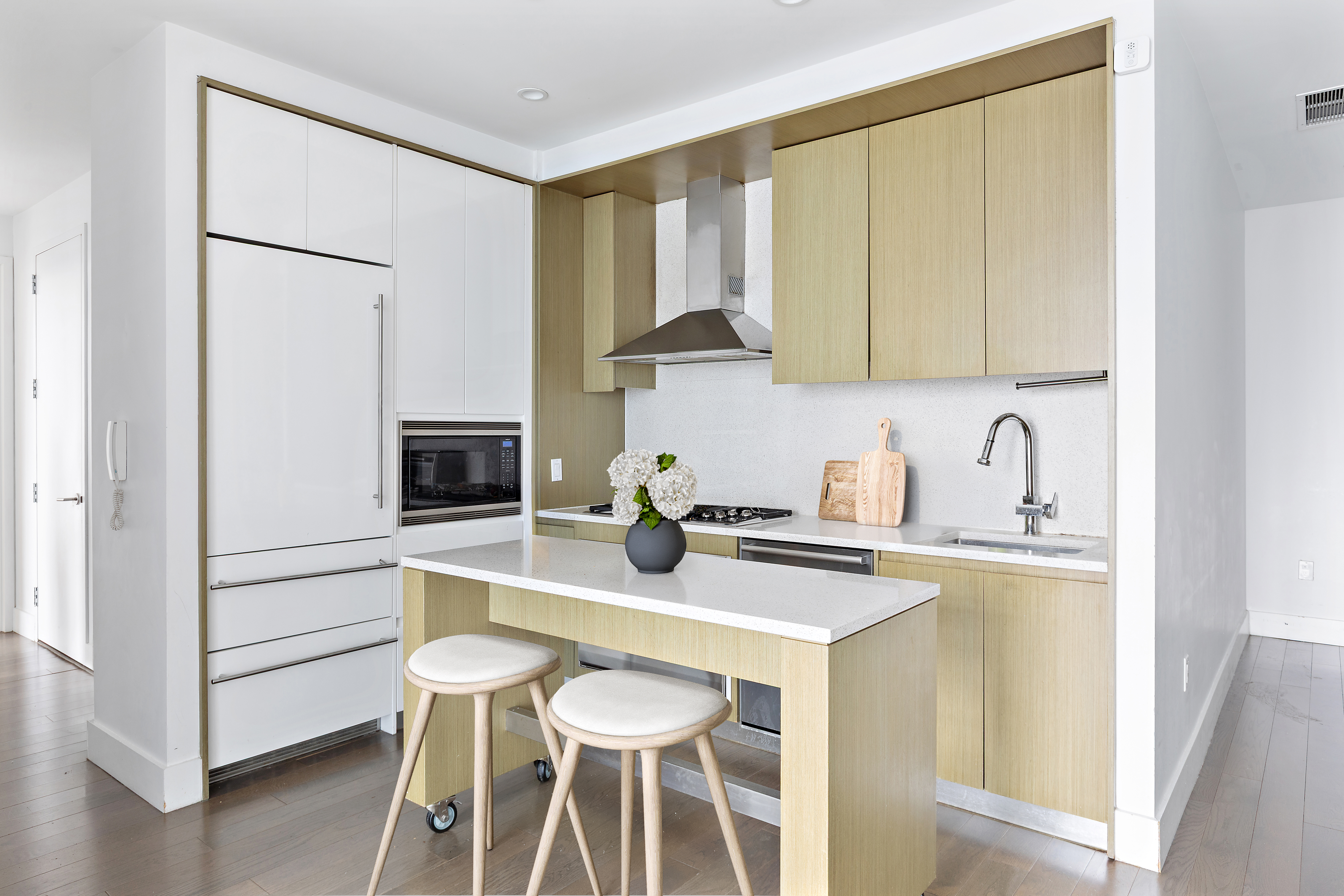 388 Bridge Street, Unit PH48D Brooklyn, NY 11201 - Photo 3 of 11 a kitchen with stainless steel appliances granite countertop a table chairs and a refrigerator