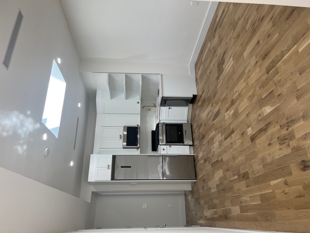 1393 Herkimer Street, Unit 2 Brooklyn, NY 11233 - Photo 2 of 9 a view of kitchen with microwave and cabinets