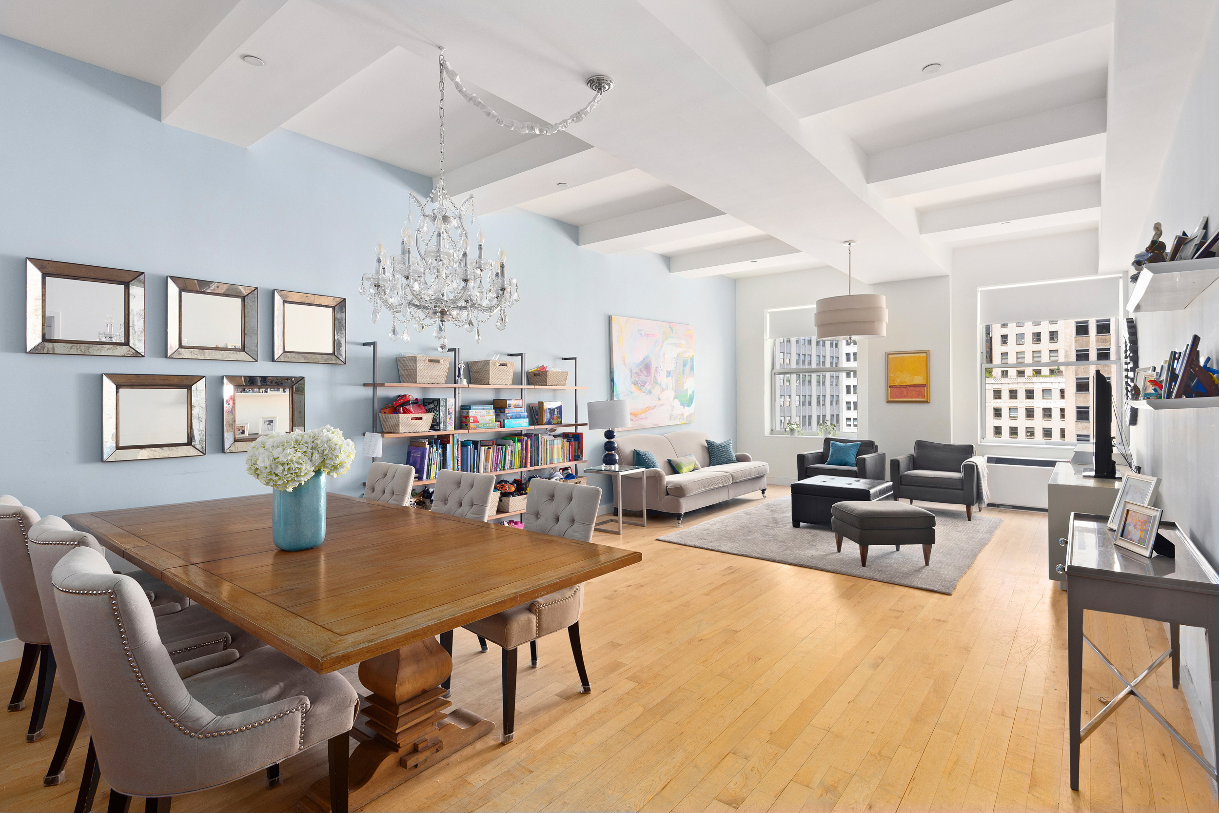a view of a dining room with furniture a chandelier and wooden floor