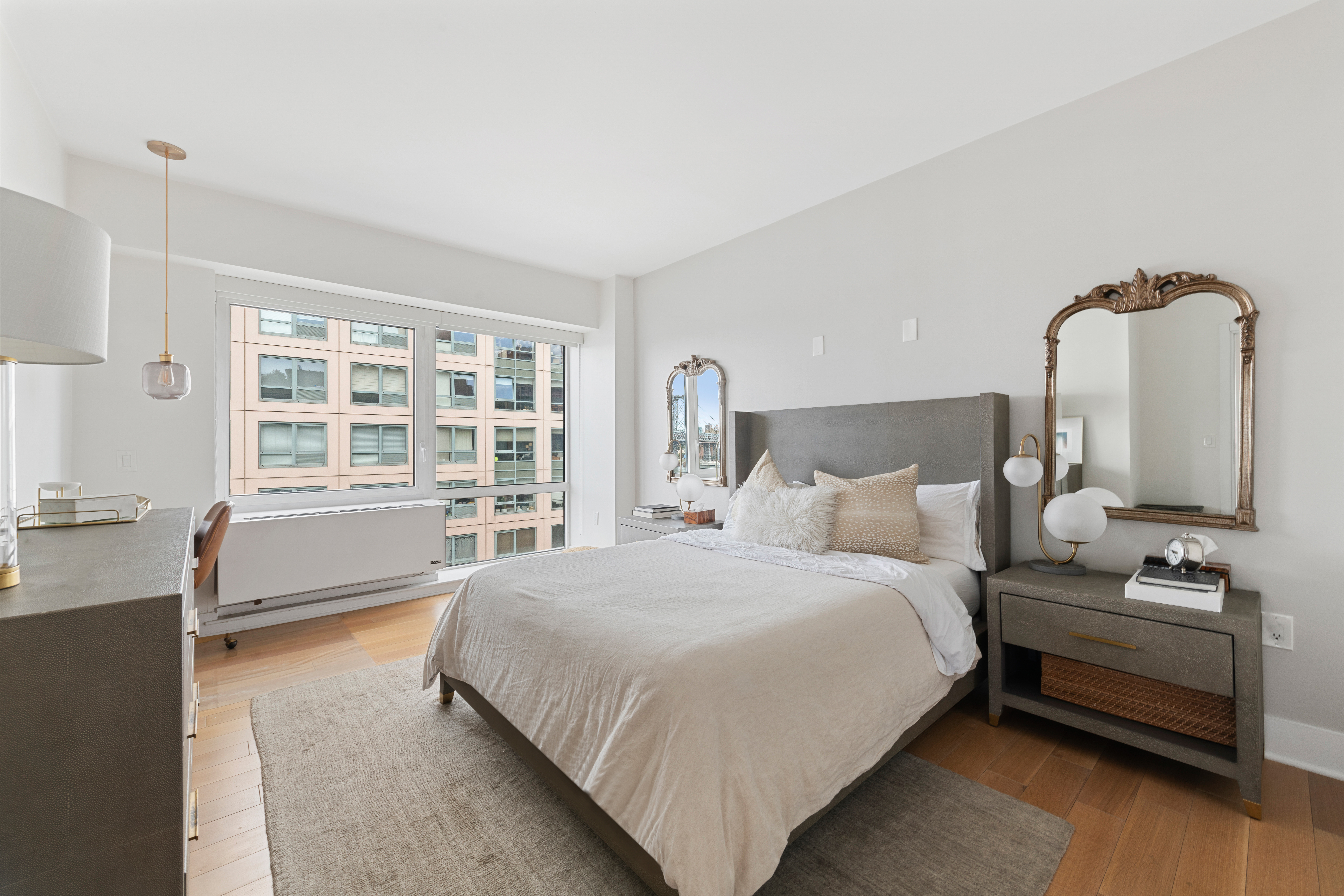 446 Kent Avenue, Unit 14A Brooklyn, NY 11249 - Photo 9 of 19 a bedroom with a bed wooden floor and window