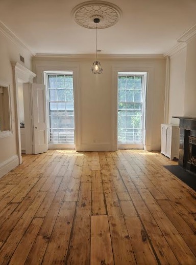 138 State Street Brooklyn, NY 11201 - Photo 4 of 13 a view of empty room with wooden floor and fan