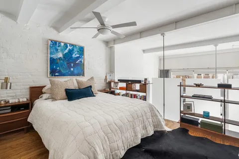 a bedroom with a large bed and a chandelier