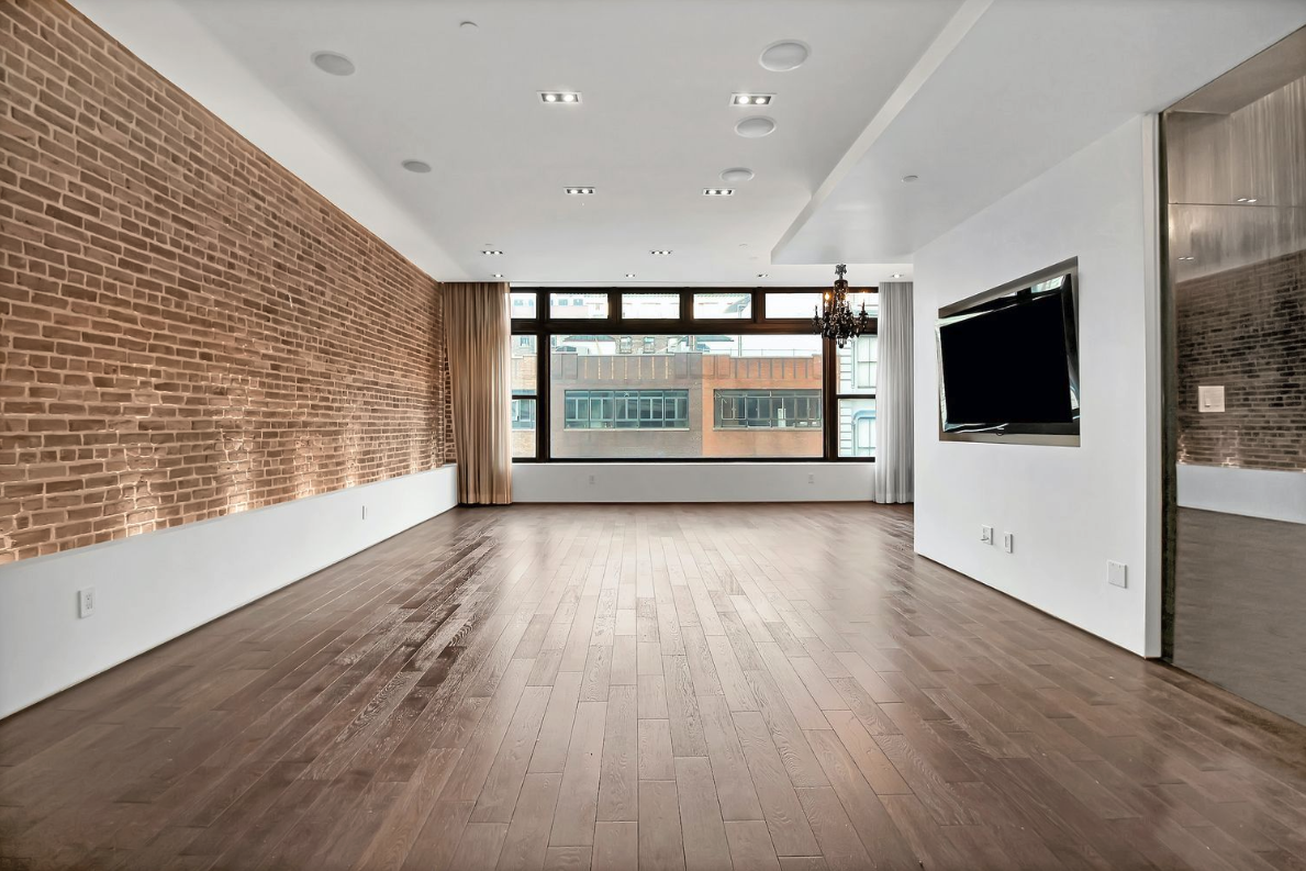 405 Broadway, Unit 4 Manhattan, NY 10013 - Photo 5 of 19 a view of empty room with wooden floor and fireplace