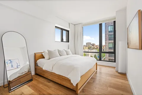 a bedroom with a large bed and a large window