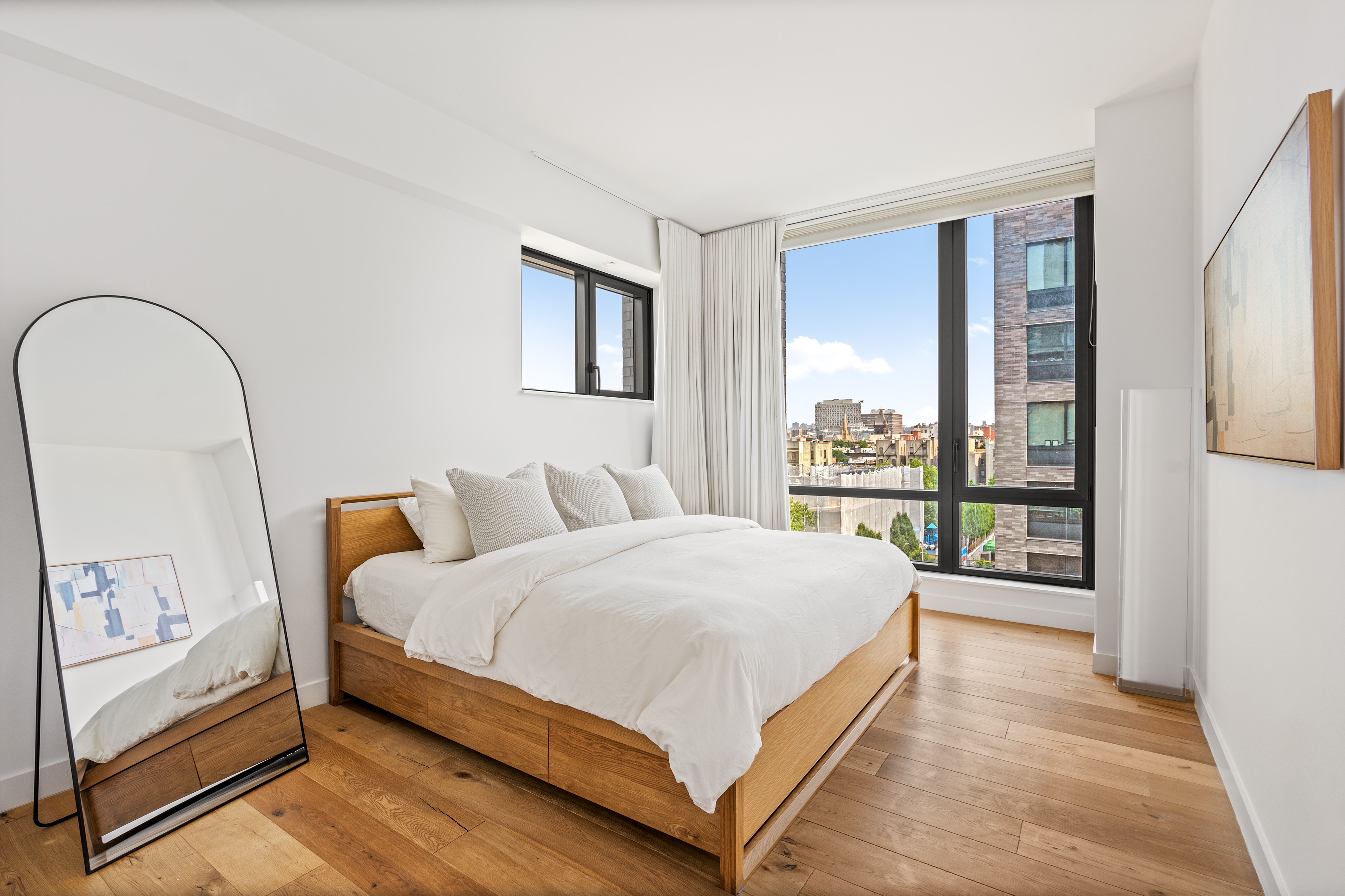 23 West 116th Street, Unit 7A Manhattan, NY 10026 - Photo 5 of 14 a bedroom with a large bed and a large window