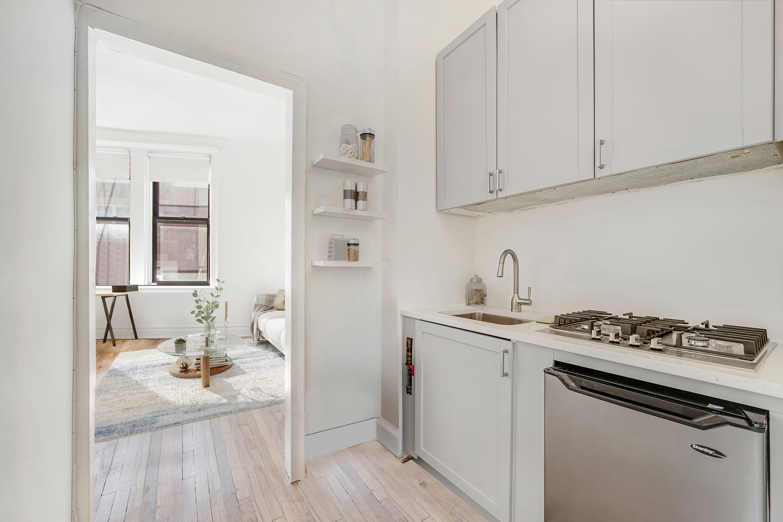 1 Sheridan Square, Unit 4E Manhattan, NY 10014 - Photo 9 of 10 a kitchen with granite countertop a sink stove and cabinets