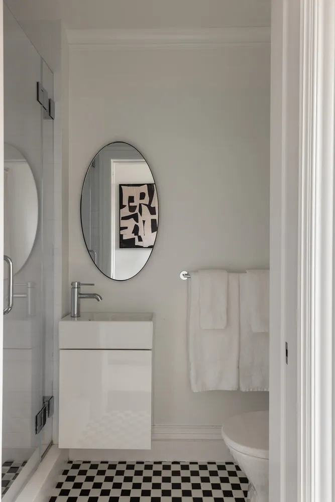 a bathroom with a sink a toilet and a mirror