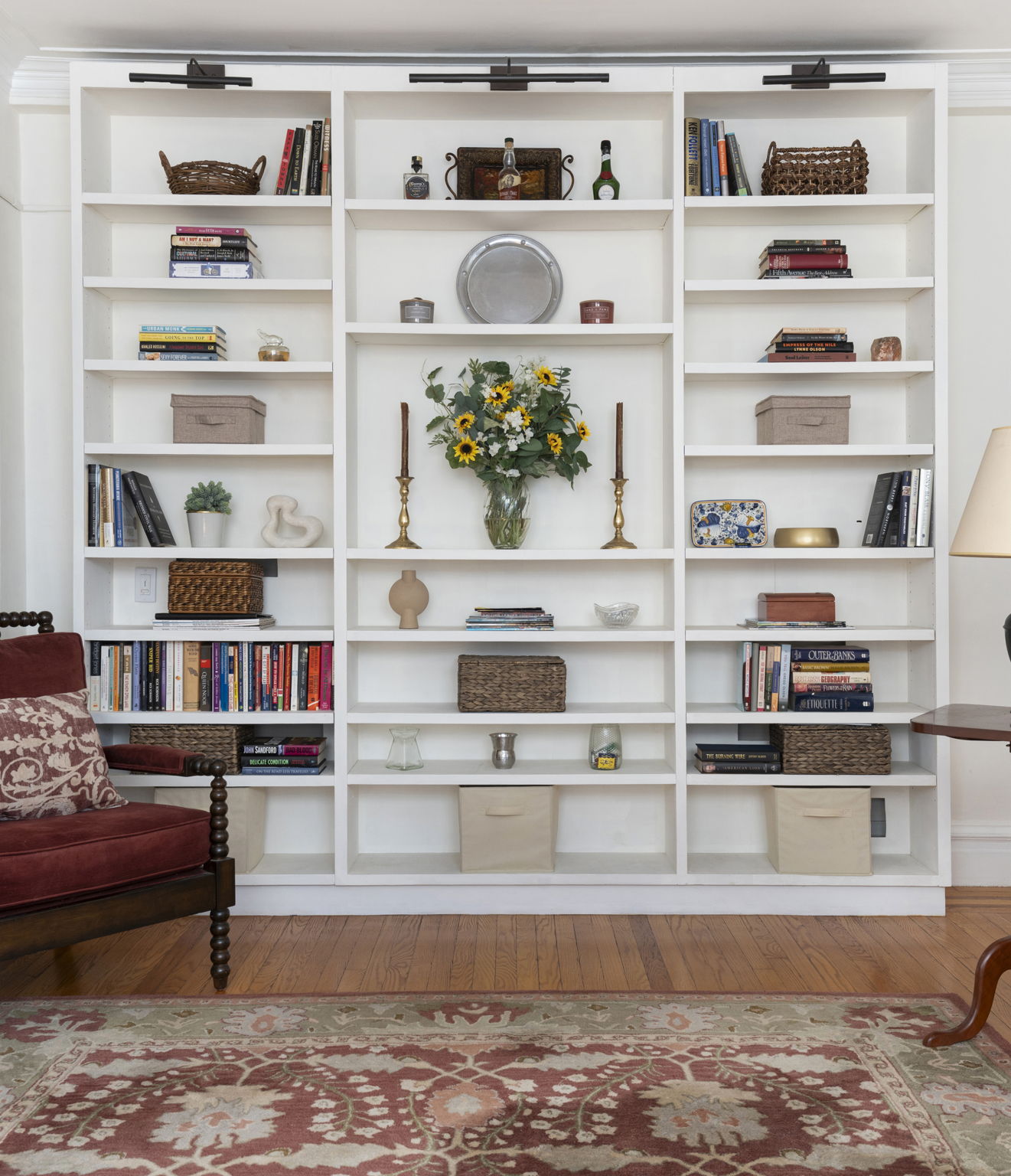136 East 36th Street, Unit 5D Manhattan, NY 10016 - Photo 1 of 13 a living room with white cabinets and a book shelf