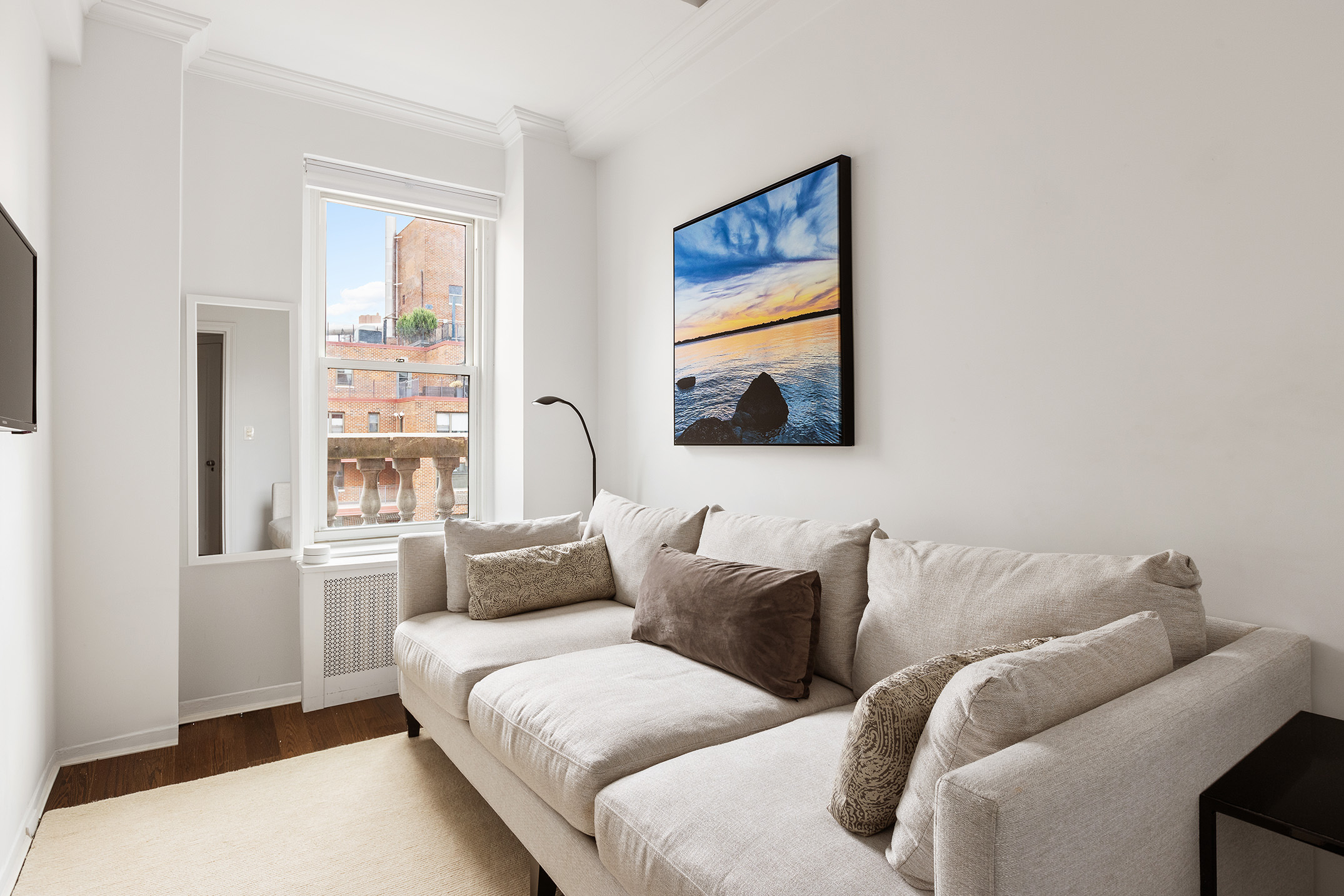 320 East 72nd Street, Unit PHB Manhattan, NY 10021 - Photo 18 of 26 a living room with furniture and a flat screen tv