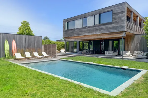a view of an house with swimming pool and porch