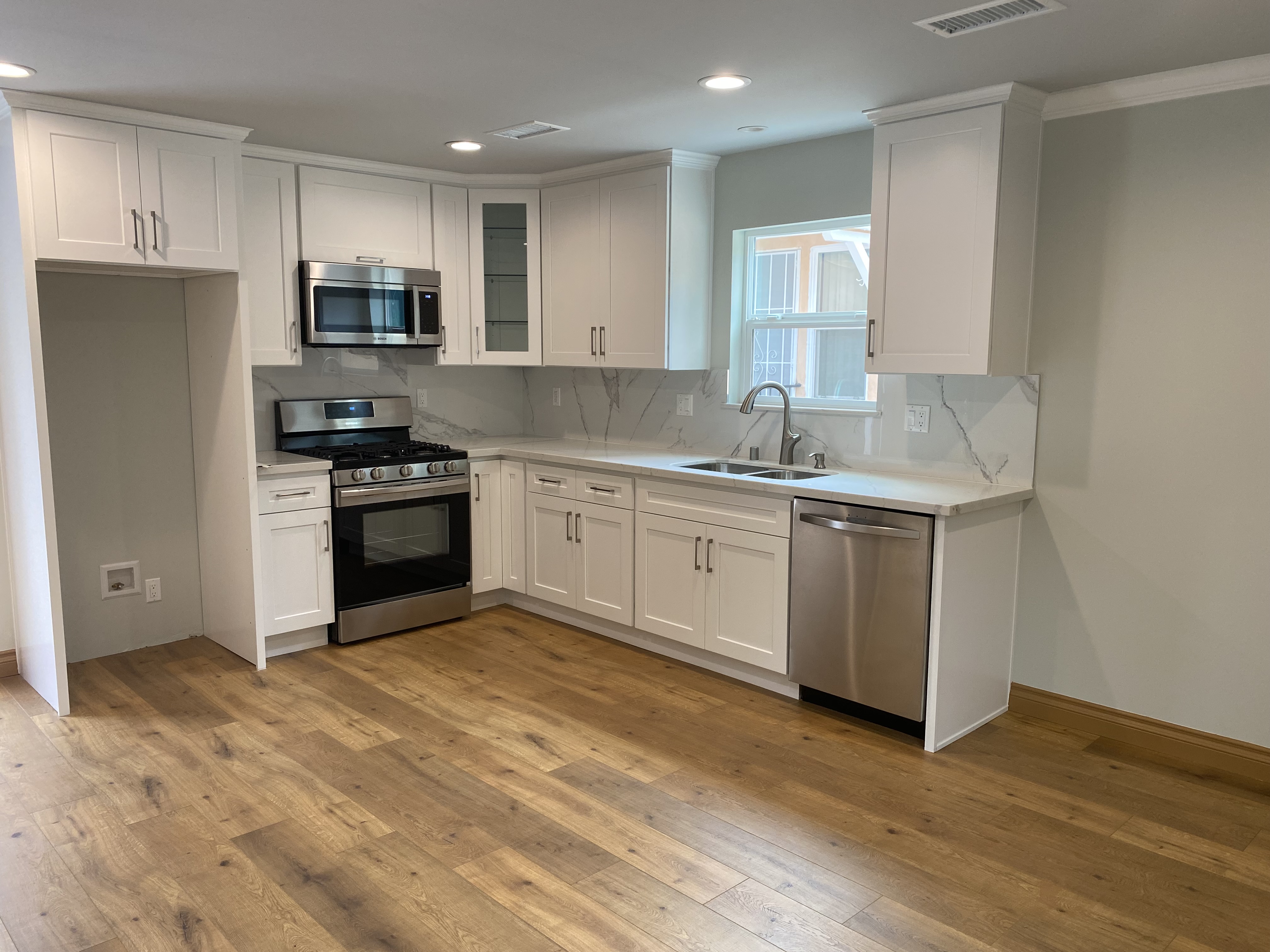5151 Nagle Avenue, Unit GUEST Sherman Oaks, CA 91423 - Photo 4 of 11 a kitchen with stainless steel appliances granite countertop a stove a sink and a microwave
