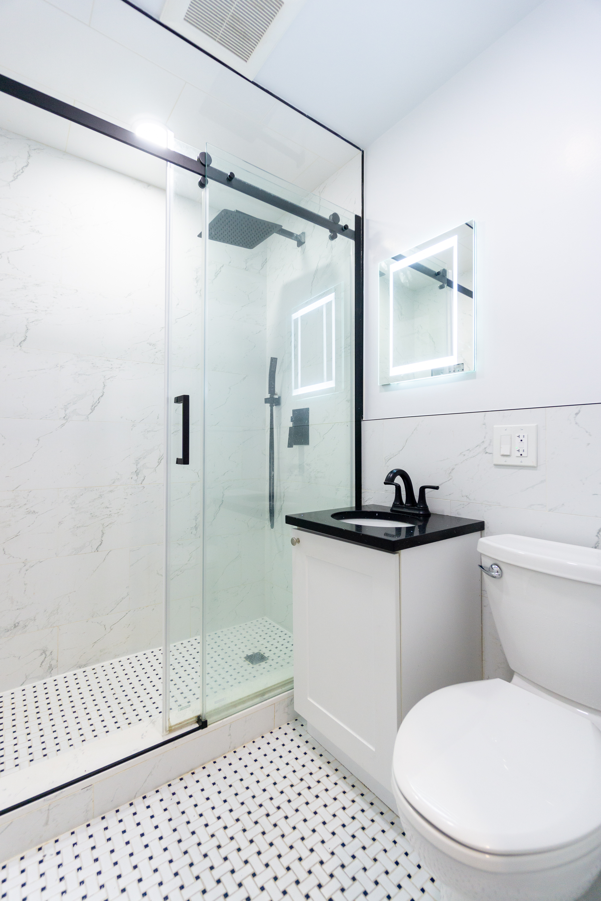 400 East 9th Street, Unit 4D Manhattan, NY 10009 - Photo 8 of 13 a bathroom with a sink toilet and shower