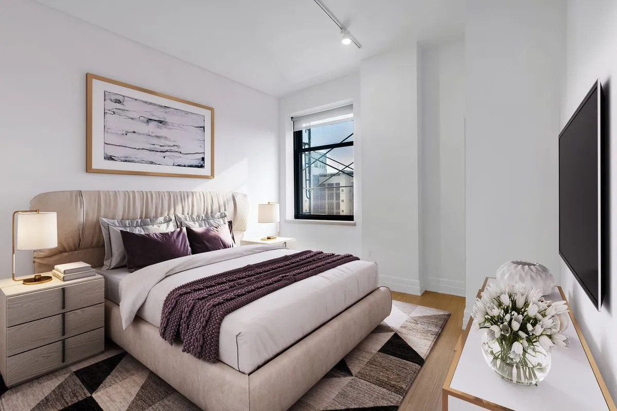 a bedroom with bed and a painting on the wall