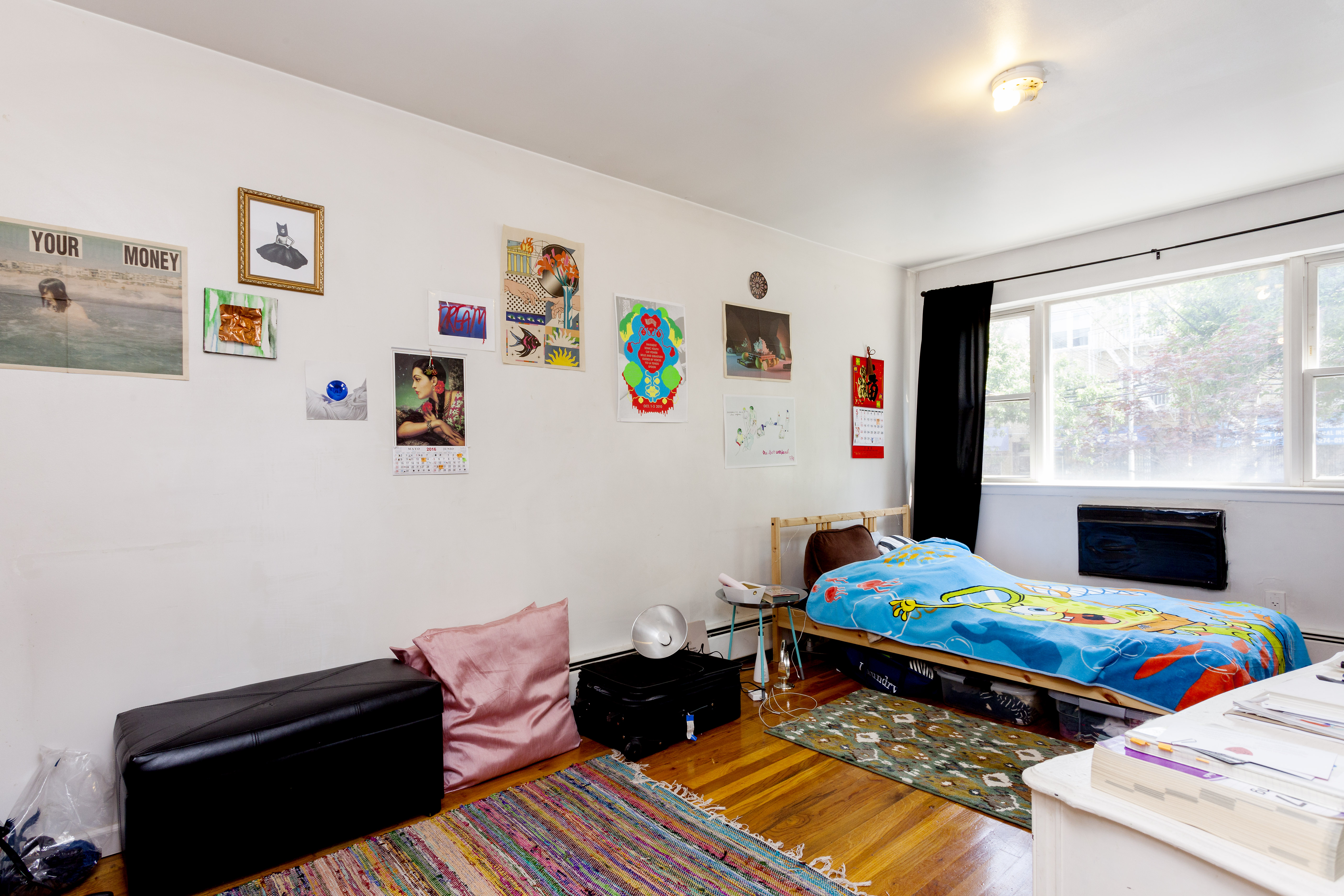 23-12 24th Avenue, Unit 1 Queens, NY 11102 - Photo 6 of 10 a bedroom with a bed window and wall painting