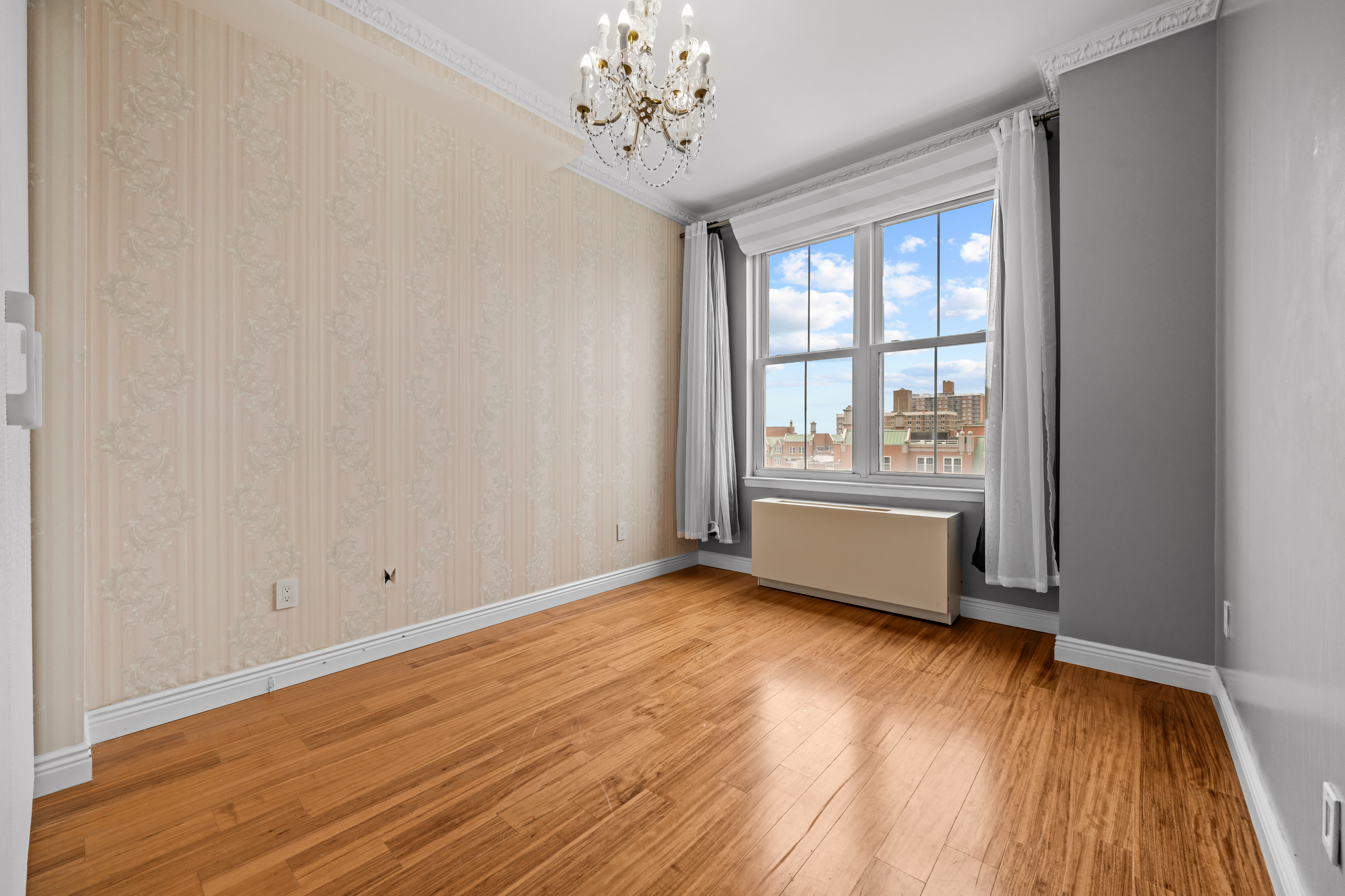 105 Oceana Drive East, Unit PH1D Brooklyn, NY 11235 - Photo 15 of 27 a view of an empty room with wooden floor and a window