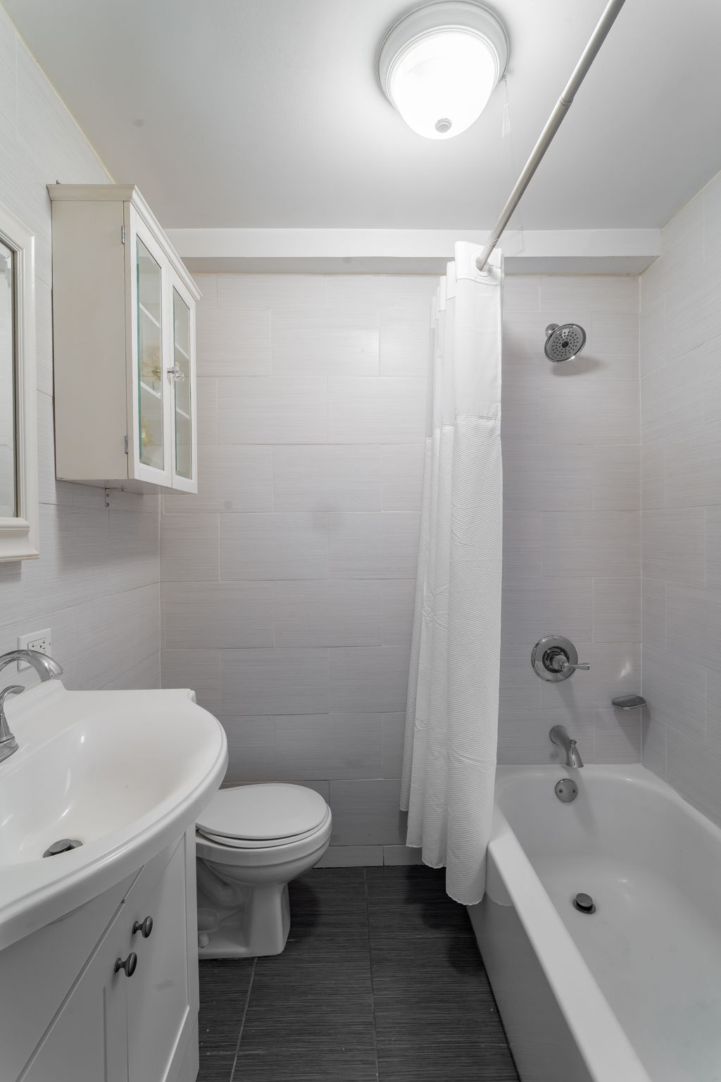 155 East 49th Street, Unit 10E Manhattan, NY 10017 - Photo 10 of 12 a bathroom with a sink toilet and shower