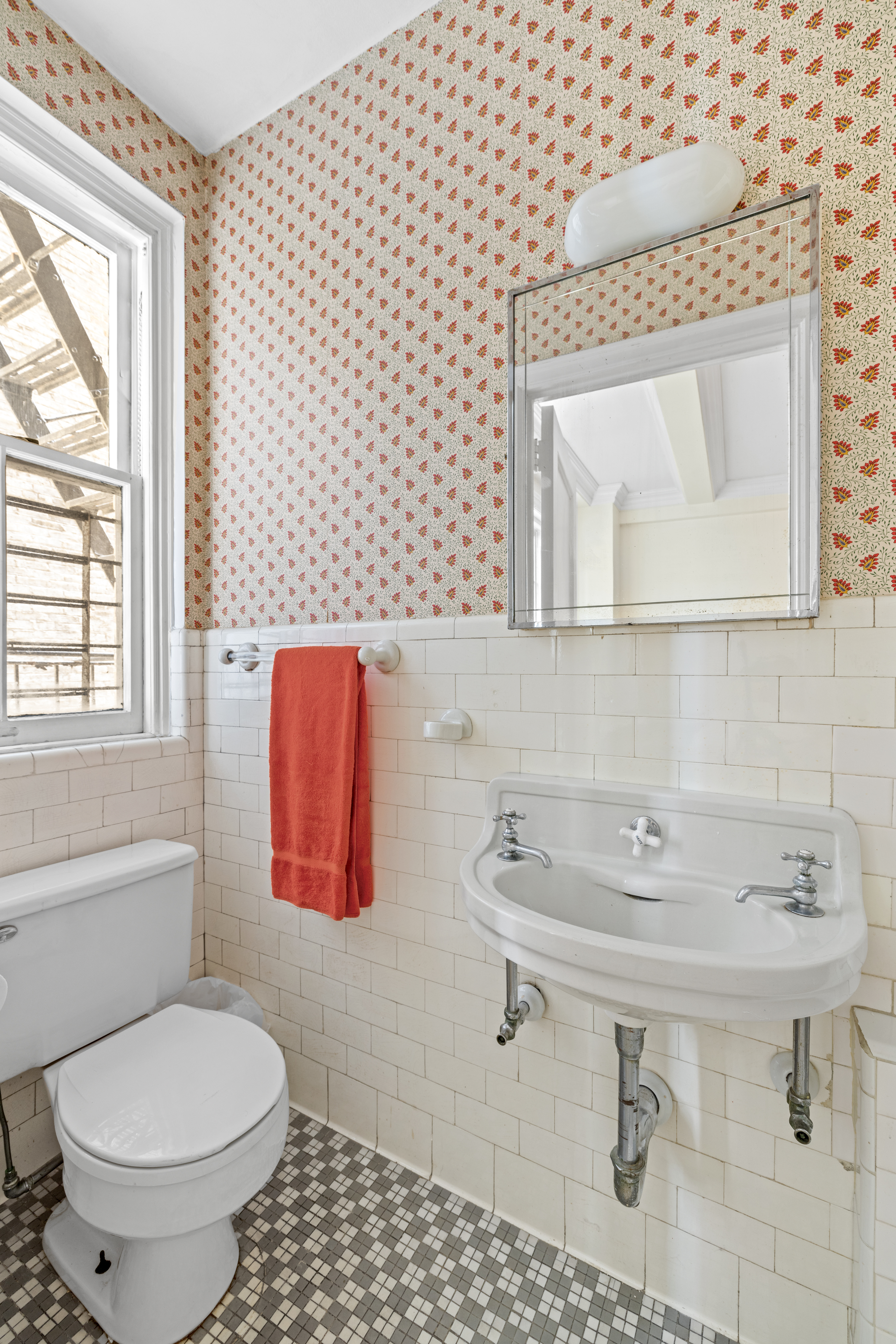 75 Central Park West, Unit 5A Manhattan, NY 10023 - Photo 11 of 14 a bathroom with a sink toilet and mirror