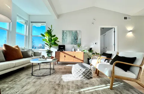 a living room with furniture and wooden floor