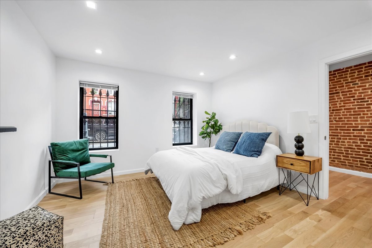 448 Halsey Street, Unit 1 Brooklyn, NY 11233 - Photo 12 of 22 a bedroom with a bed and a lamp
