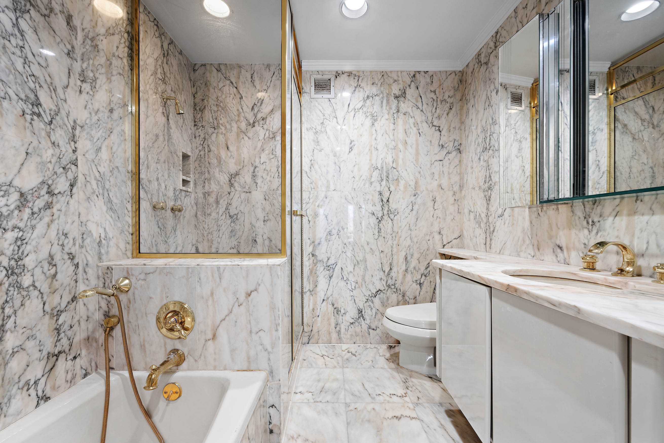 530 East 76th Street, Unit PH36/37E Manhattan, NY 10021 - Photo 16 of 29 a bathroom with a sink a toilet and shower curtain