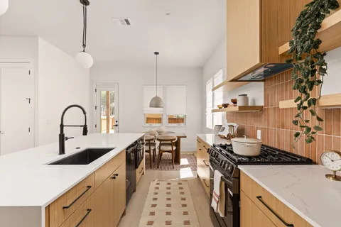 a kitchen with sink stove and cabinets