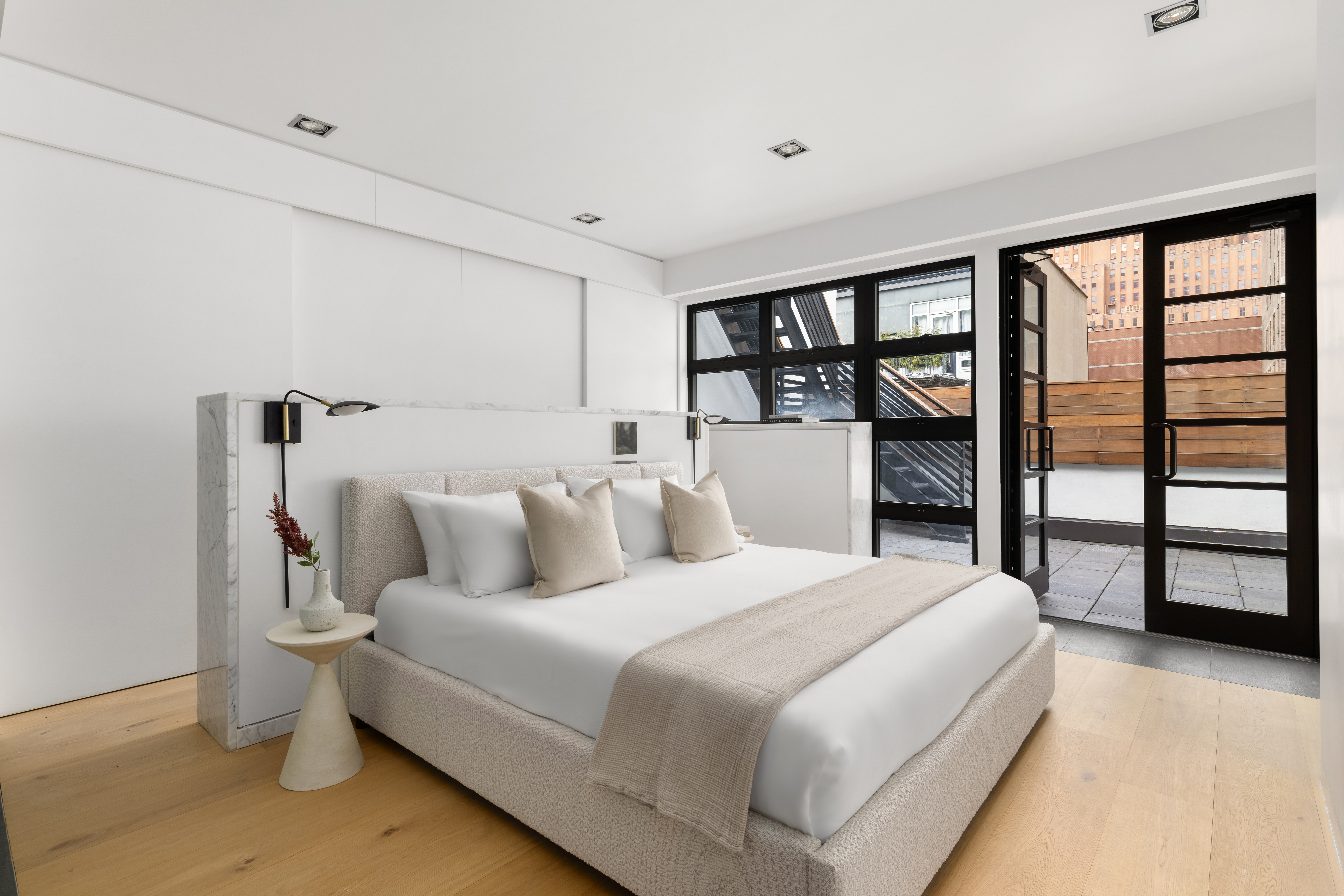 74 Warren Street, Unit 5W Manhattan, NY 10007 - Photo 8 of 15 a bedroom with a large bed and a large window