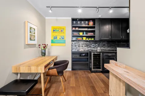 a kitchen with a wooden cabinets and chairs