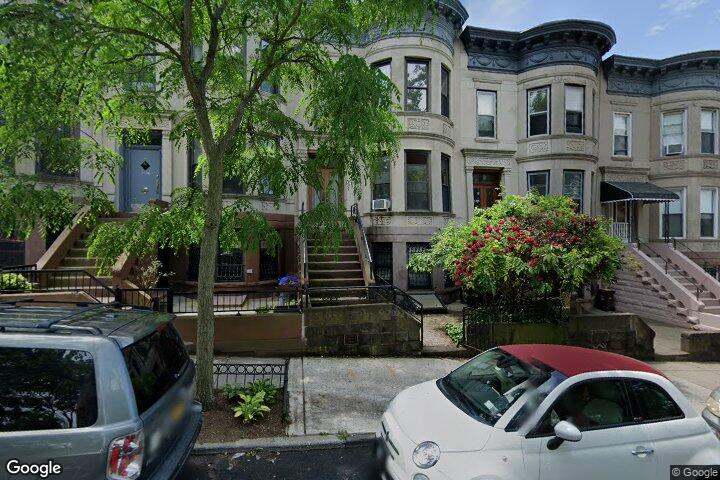 a front view of a house with yard and seating area