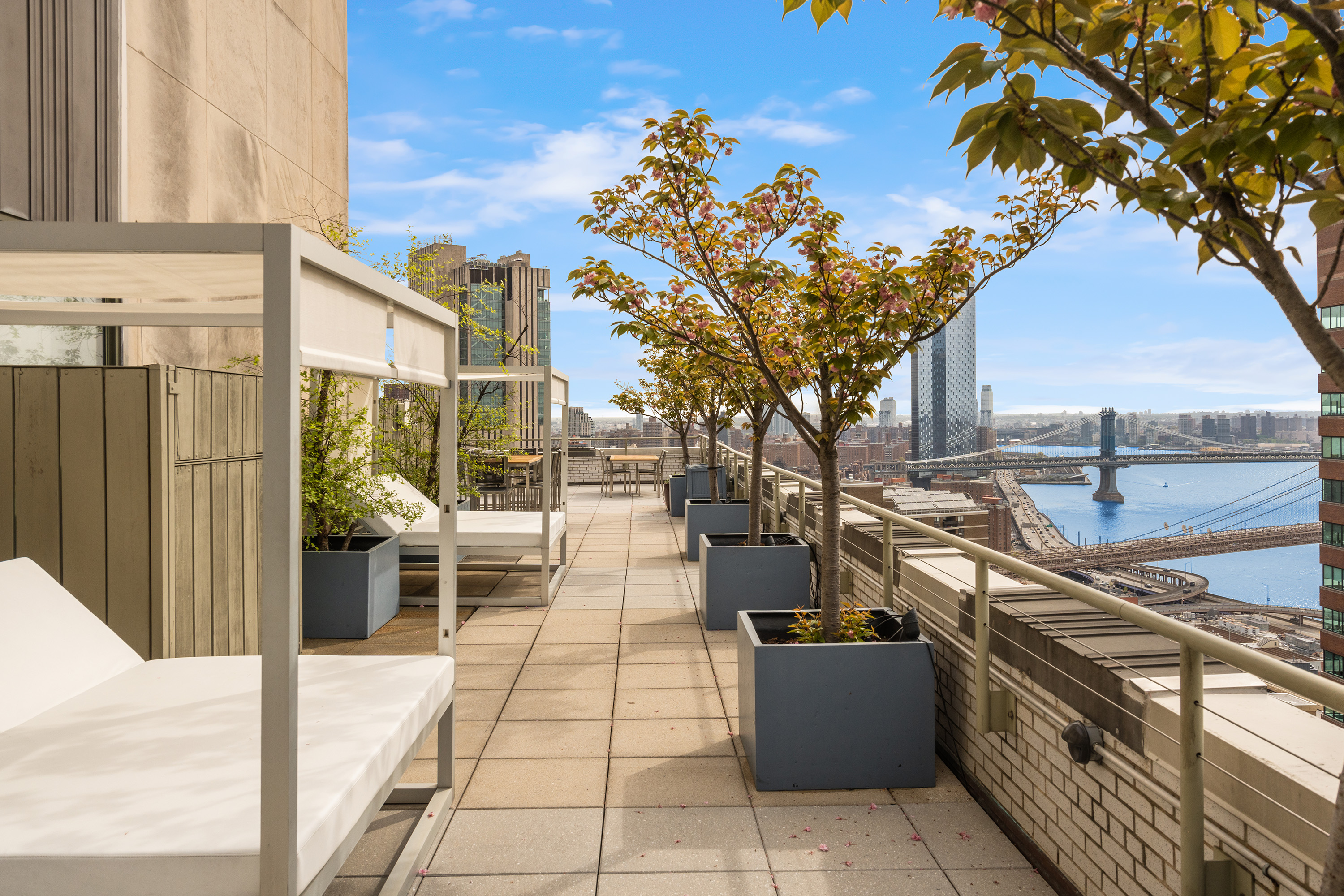 99 John Street, Unit 922 Manhattan, NY 10038 - Photo 9 of 14 a view of a patio with couches and table with wooden floor and fence