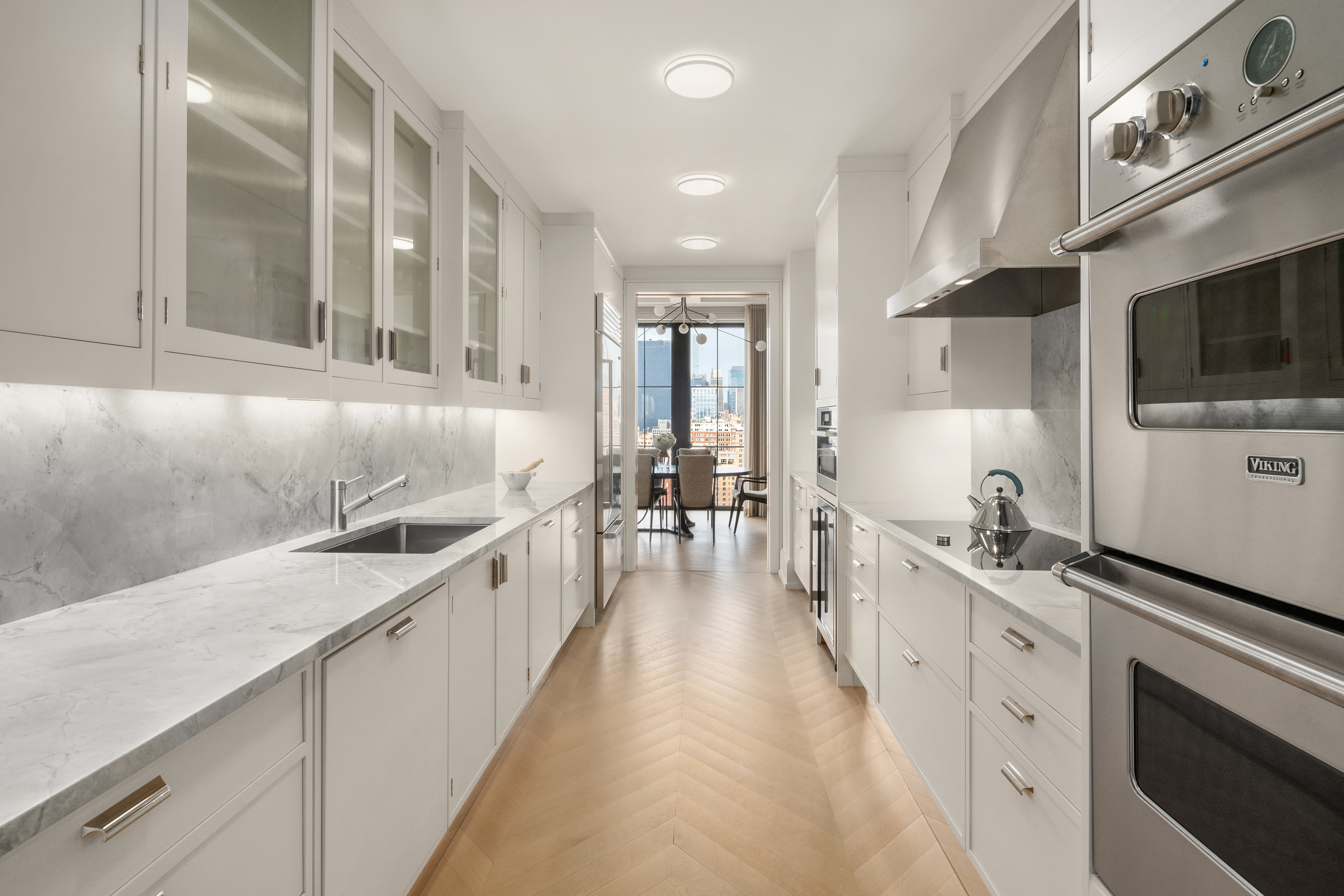 212 West 18th Street, Unit 19C Manhattan, NY 10011 - Photo 6 of 27 a large white kitchen with a large window