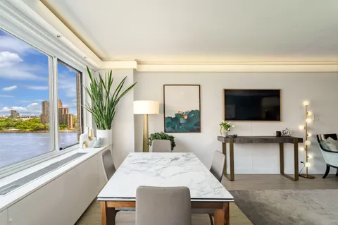a dining room with furniture and a flat screen tv