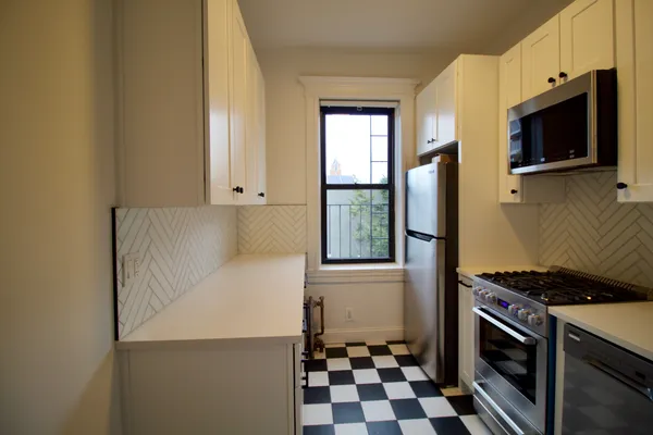 a kitchen with stainless steel appliances a stove a microwave and a refrigerator