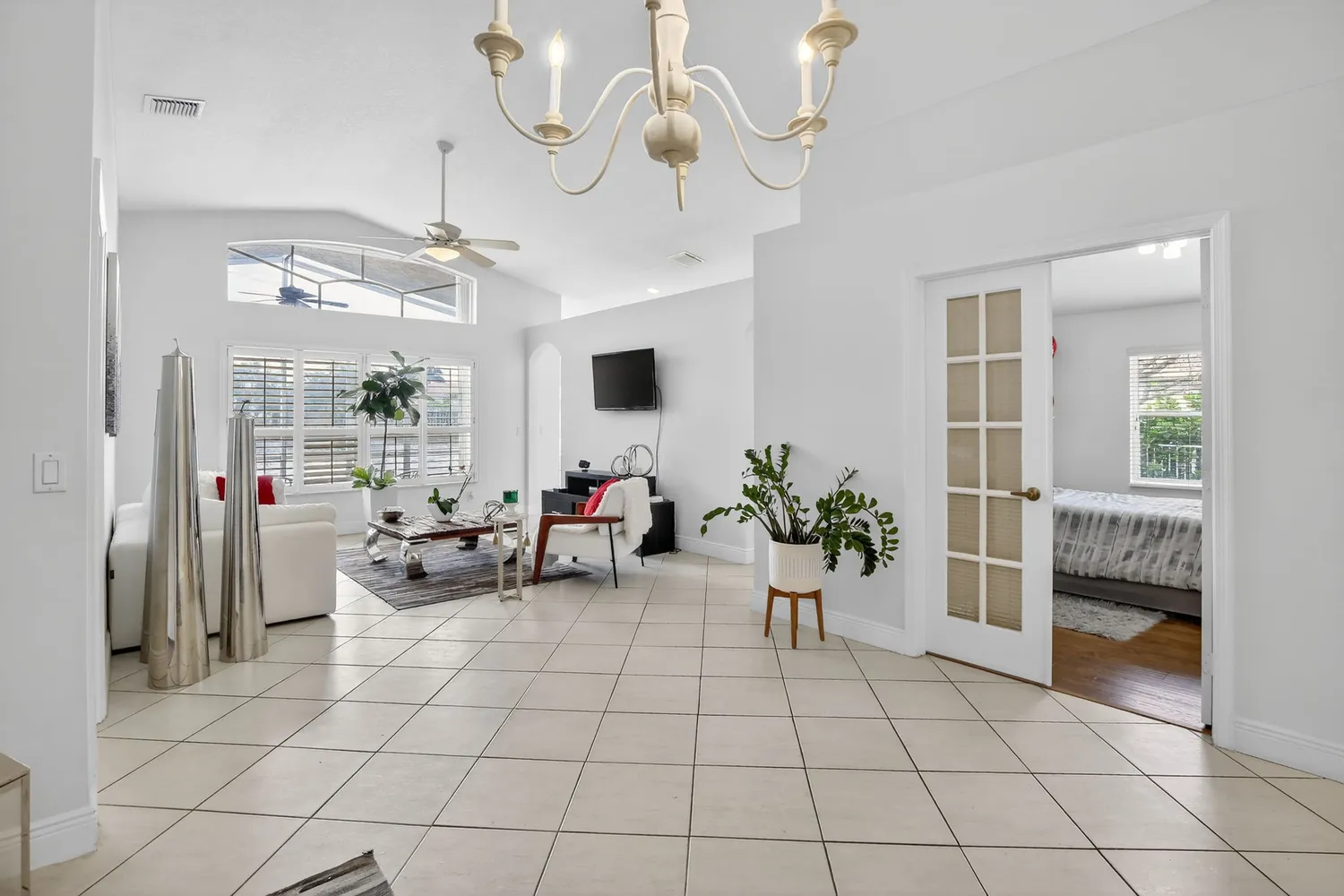 a view of a livingroom with furniture and a chandelier fan