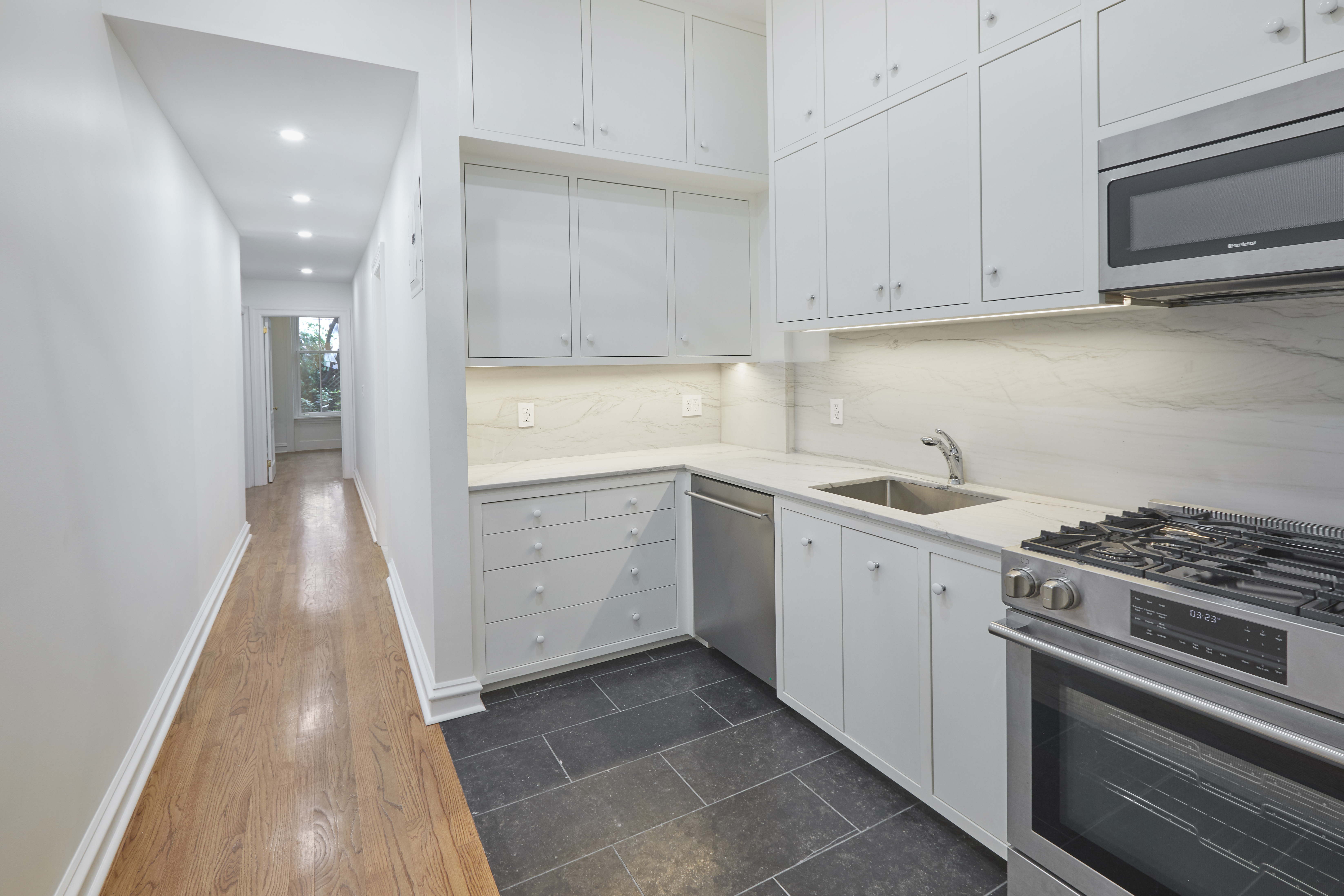 157 East 75th Street, Unit 1E Manhattan, NY 10021 - Photo 14 of 21 a kitchen with a sink stove and cabinets