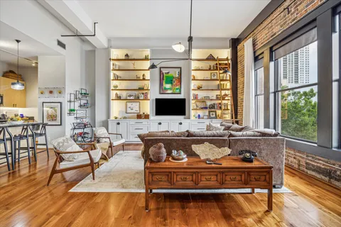 a living room with fireplace furniture and a flat screen tv