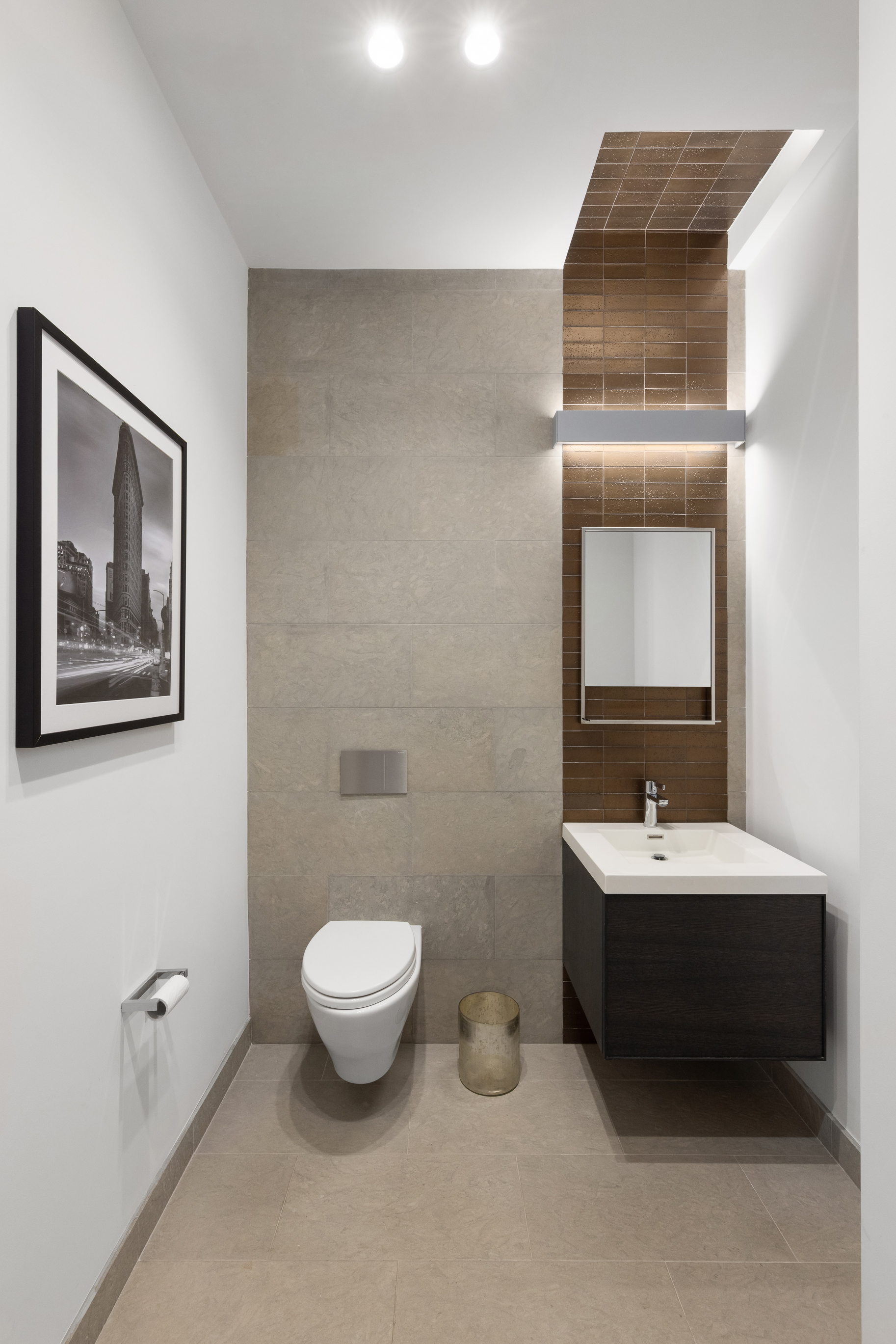 88 Lexington Avenue, Unit 1606 Manhattan, NY 10010 - Photo 17 of 20 a bathroom with a toilet sink and mirror