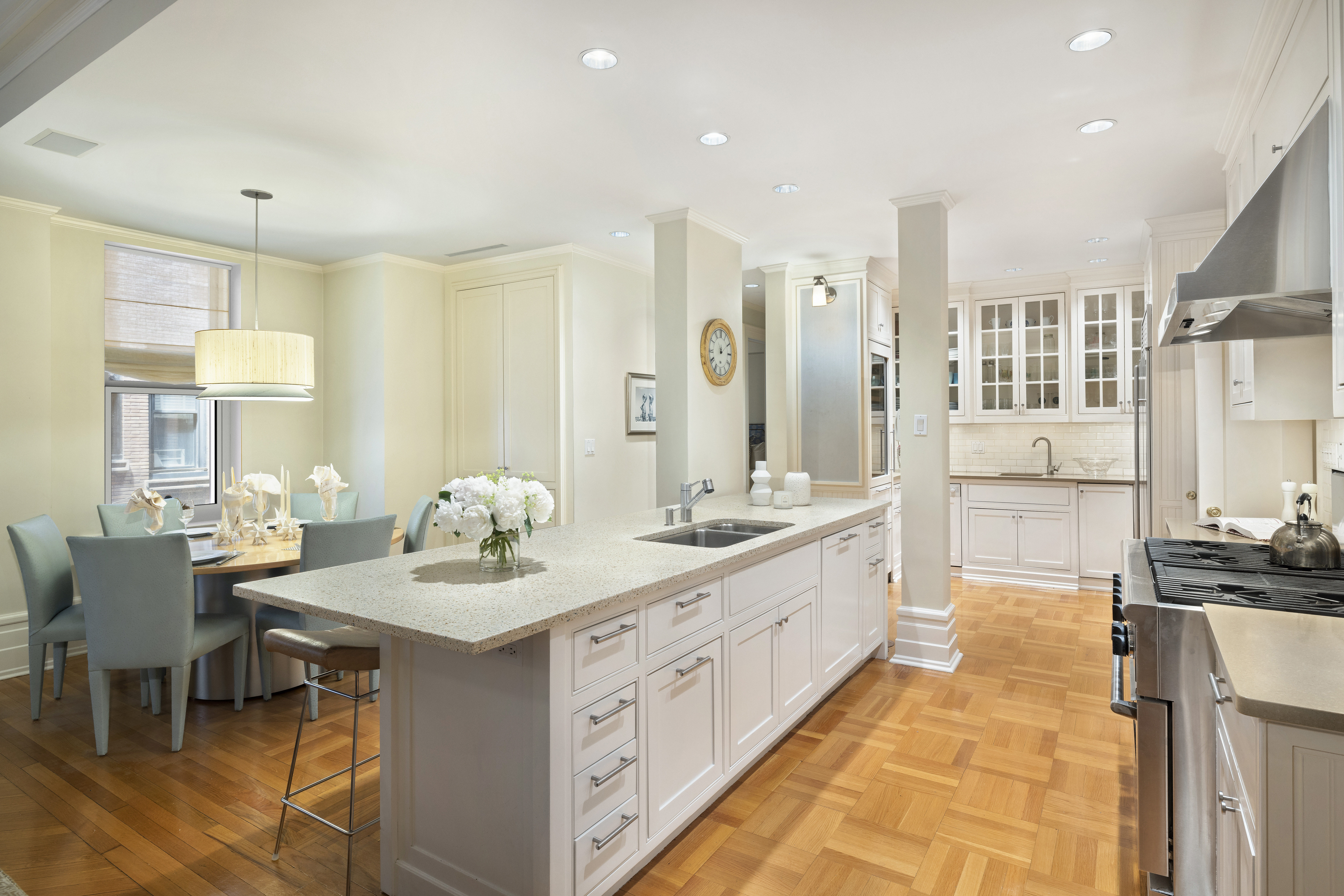 325 West End Avenue, Unit 6AB Manhattan, NY 10023 - Photo 8 of 22 a large white kitchen with a large counter top appliances and cabinets