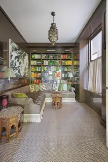 a living room with furniture a chandelier and a large window