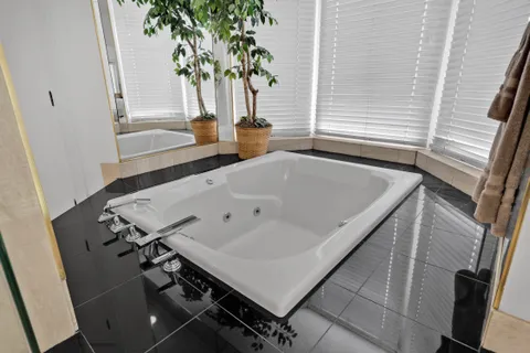 a kitchen with stainless steel appliances granite countertop a table and chairs in it