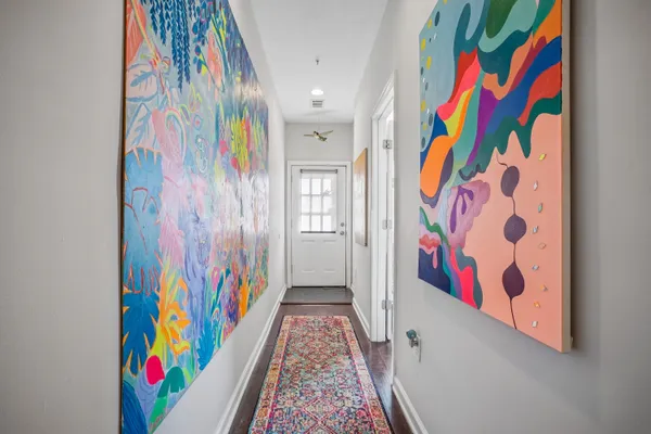 a room with painting on the wall and shower curtain