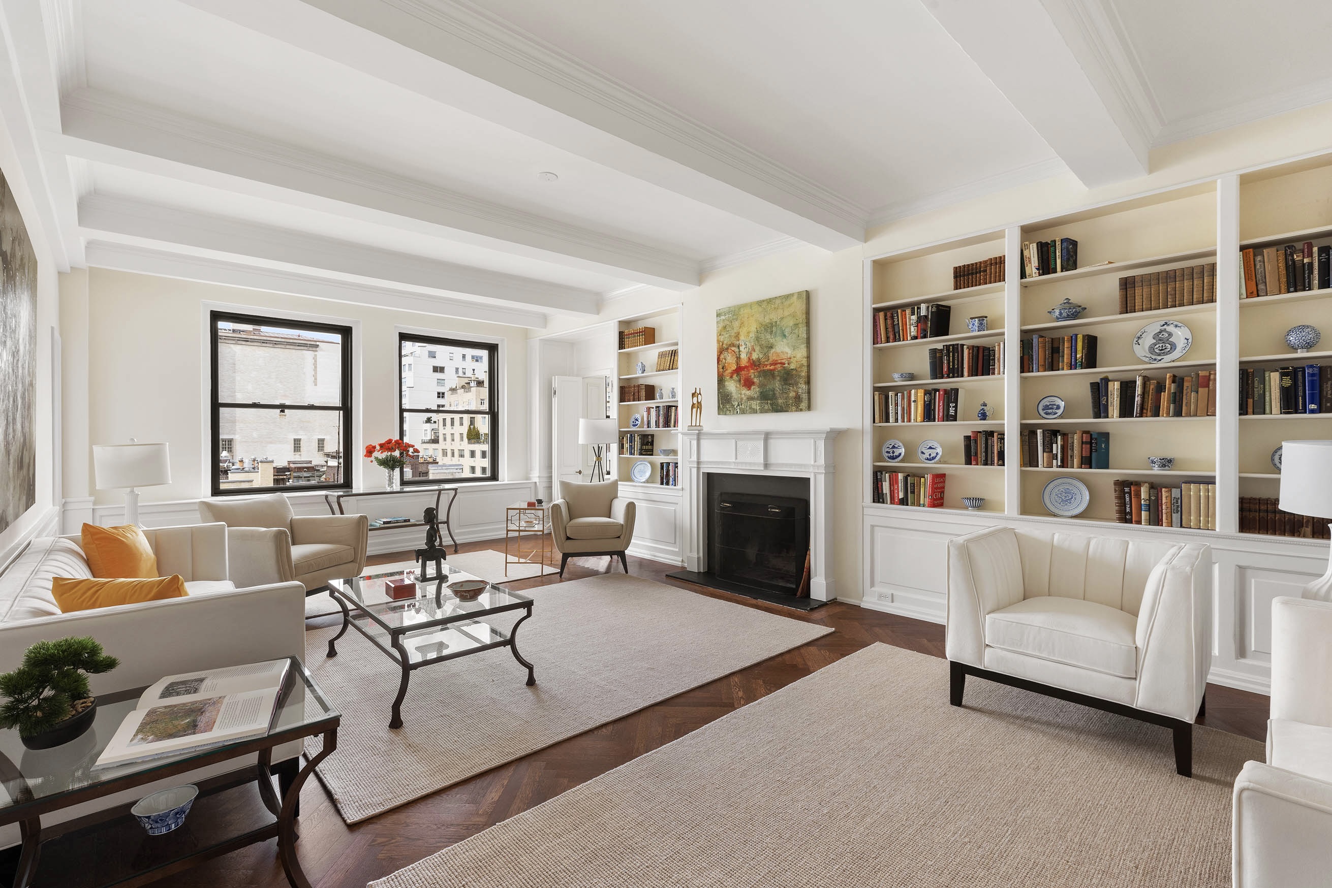 33 East 70th Street, Unit 9C Manhattan, NY 10021 - Photo 1 of 12 a living room with furniture and a fireplace
