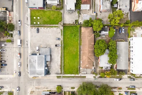 front view of a house with a yard and potted plants