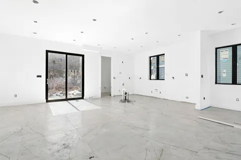 an empty room with windows and closet