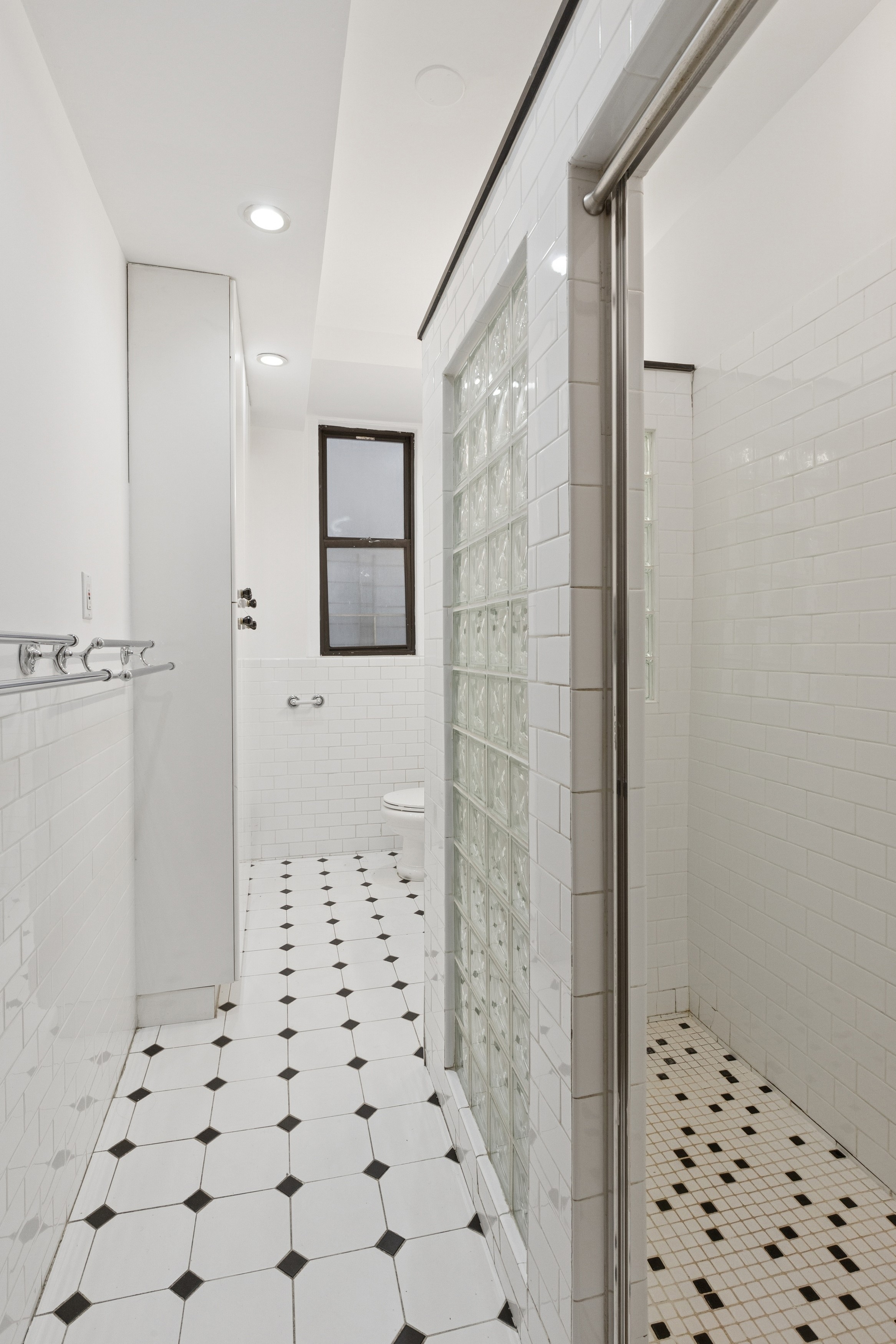 804 West 180th Street, Unit 41 Manhattan, NY 10033 - Photo 16 of 23 a bathroom with a shower and a toilet