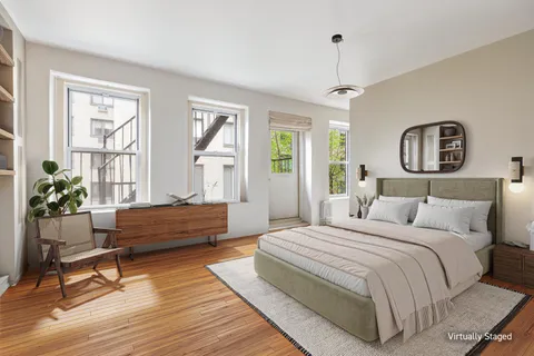 a spacious bedroom with a bed and a window