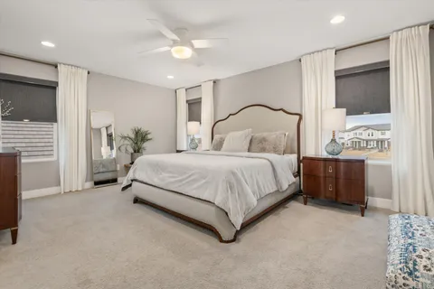 a bedroom with a large bed and a chandelier