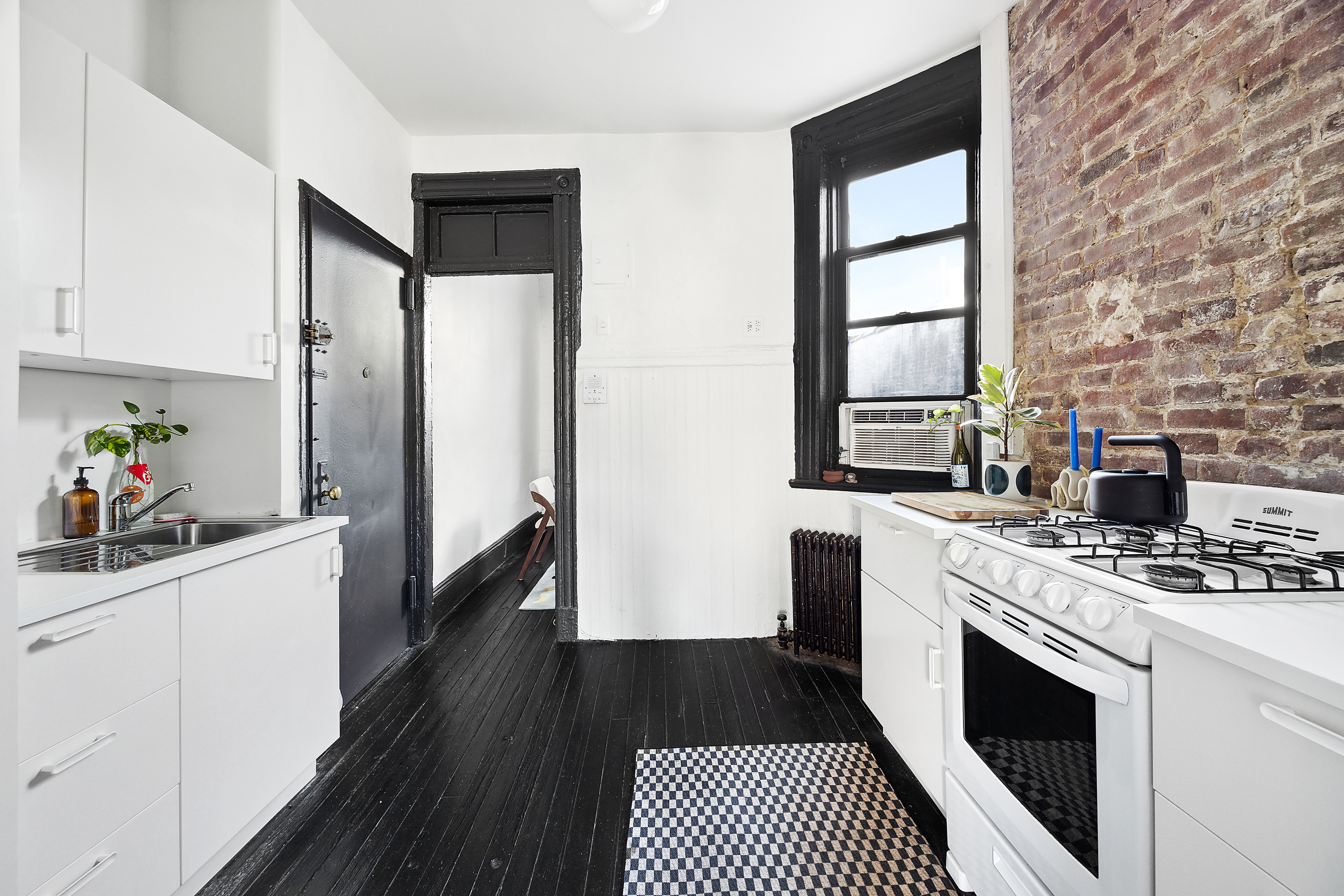 633 East 11th Street, Unit 23 Manhattan, NY 10009 - Photo 4 of 8 a kitchen with stainless steel appliances a stove a sink and a refrigerator